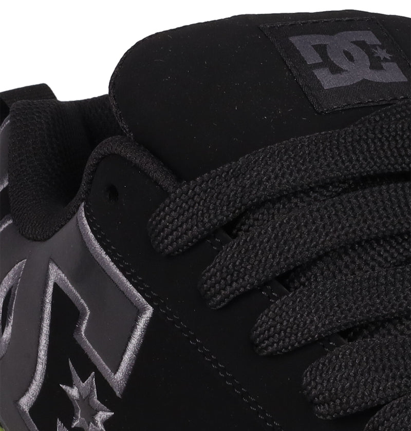 Close-up of the DC Shoes Men's Court Graffik SE—a black skate shoe with a puffy silhouette, thick black laces, and the DC logo in white and gray on the side and tongue.