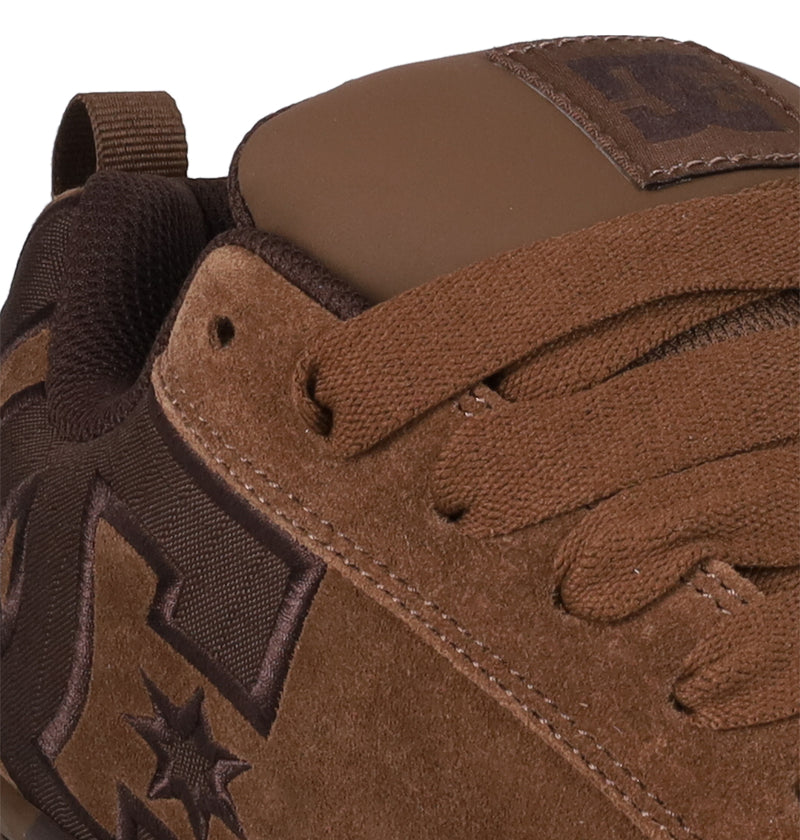 Close-up of DC Shoes Men's Court Graffik SE sneaker in brown suede with matching laces and embroidered star and letter details. Premium upper materials and precise stitching highlight the craftsmanship.