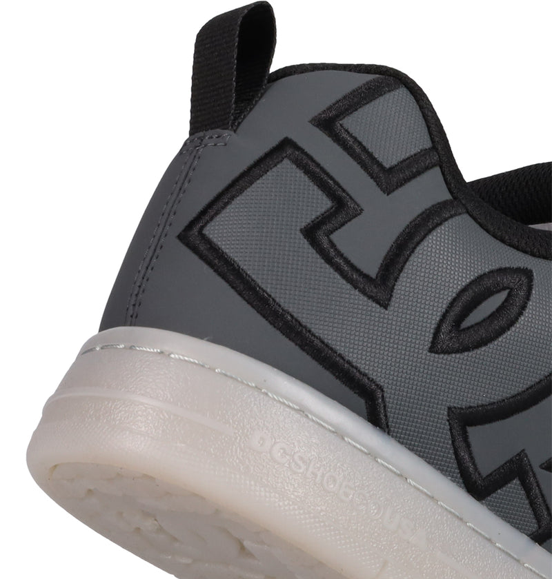 Close-up of the heel and side of the DC Shoes Men's Court Graffik SE, a gray sneaker with bold black stitching, puffy silhouette, white sole, and black heel pull tab for an updated streetwear look.