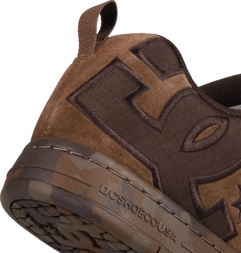 Close-up of the heel of DC Shoes Men's Court Graffik SE Shoes, featuring a puffy silhouette, large embroidered lettering, fabric pull tab, and DCSHOECOUSA on the camo-patterned rubber sole.