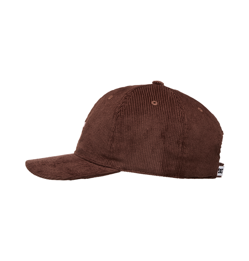 The Men's DC Cap Star Strapback by DC Shoes is displayed in side profile against a white background, showcasing its brown corduroy texture, curved brim, DC branding, and a small tag at the back.