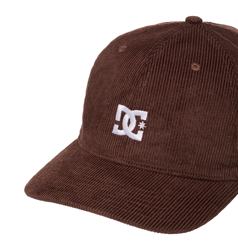 The Men's DC Cap Star Strapback by DC Shoes is a brown corduroy skate cap with a curved brim and white embroidered DC logo on the front, displayed against a plain white background.