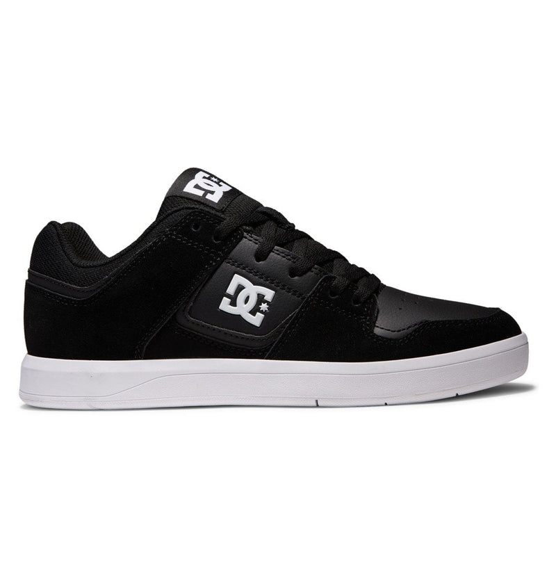 The Men's DC Cure Shoes by DC Shoes feature a black low-top design with a white sole, white DC logo on the side and tongue, black laces, and padded collar—ideal for everyday street style.