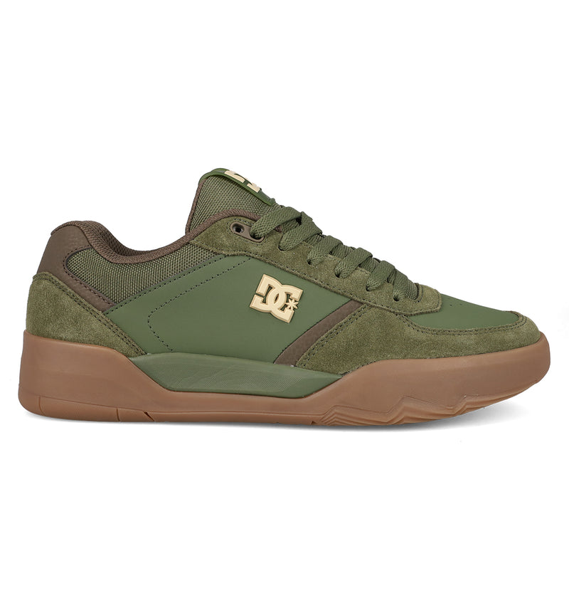 The DC Shoes Men's Fractal features green suede and mesh with brown accents, a gold side logo, green laces, and a brown rubber sole. Shown from the side on a white background, this street-ready sneaker blends style and durability.