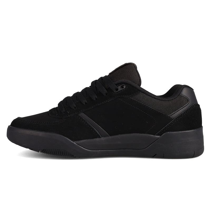 The DC Shoes Men's Fractal Shoes feature a black low-top design with suede and mesh panels, black laces, and a thick black rubber sole, offering street-ready style and comfort. Shown in side profile on a white background.
