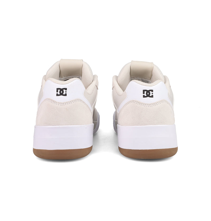 A pair of Men's Fractal Shoes by DC Shoes shown from the back, featuring white uppers, beige suede accents, white midsoles, gum rubber outsoles, and black DC logos on the heels for a street-ready look.