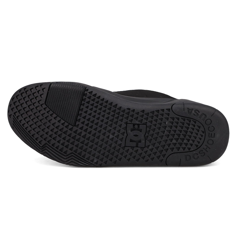 The image shows the black rubber sole of DC Shoes Men's Fractal Shoes, with a geometric fractal-inspired grip pattern, the DC Shoes logo at the center, and "DC SHOES" and "USA" embossed near the heel.