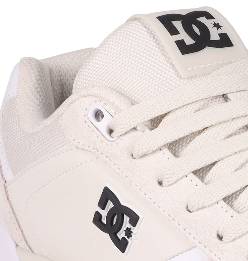 Close-up of DC Shoes Men's Fractal Shoes in white, featuring visible black DC branding on the tongue and side, detailed laces, and a stylish design that combines street-ready looks with comfort.
