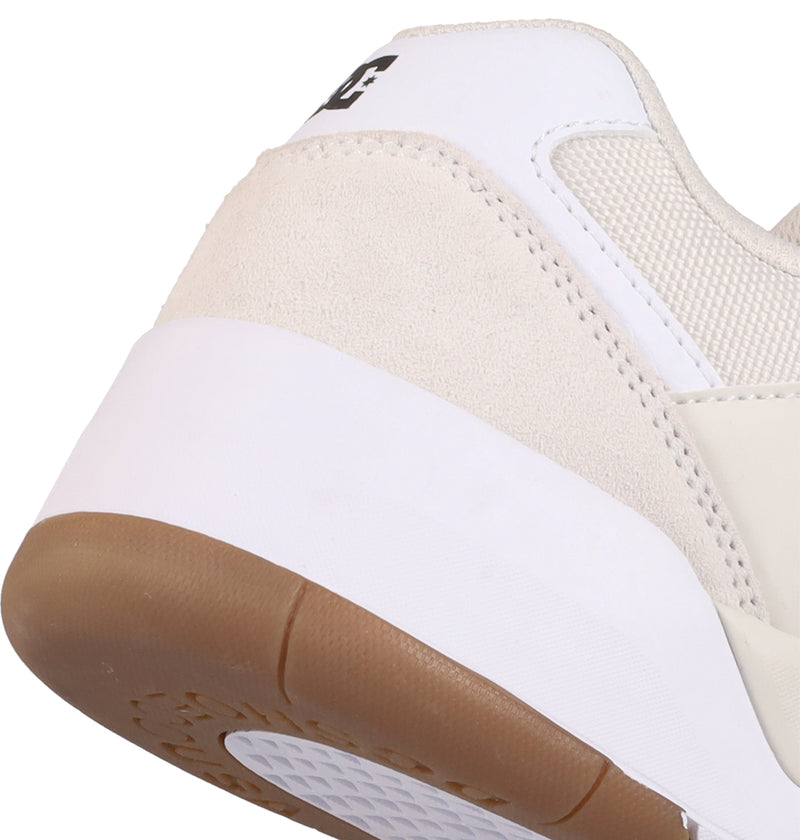 Close-up of the back portion of DC Shoes Men's Fractal Shoes in white and beige, featuring a gum sole, textured details, and a partial DC logo on the heel for added street style.