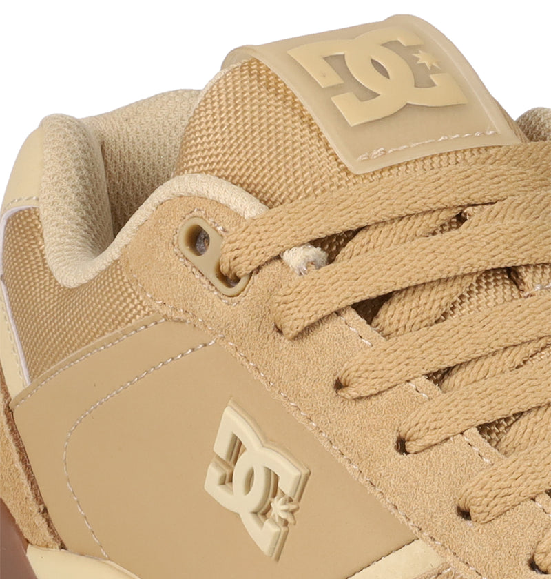 Close-up of the Men's Fractal S Shoes by DC Shoes, featuring textured tan suede and fabric, matching laces, and raised DC Shoes logos on the side and tongue for a street-ready look.