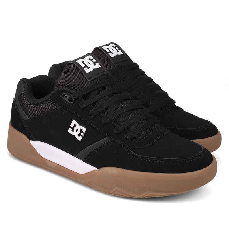 The Men's Fractal S Shoes by DC Shoes feature a black low-top design with white DC logos, black laces, brown rubber soles, and a white accent on the side—combining street-ready style with performance-driven comfort.