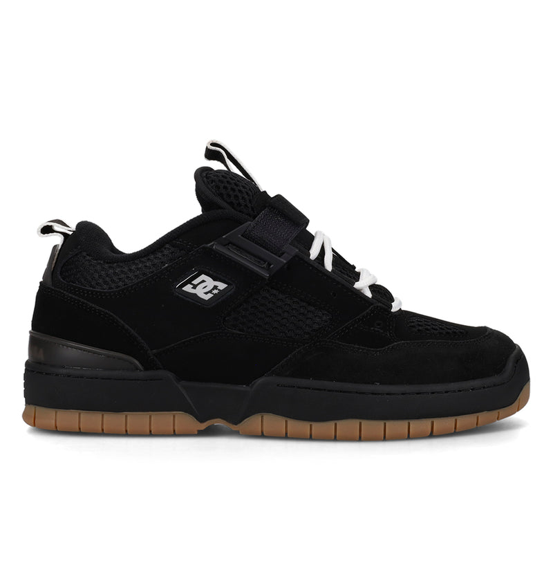Black sneaker with a visible brand logo on a white background