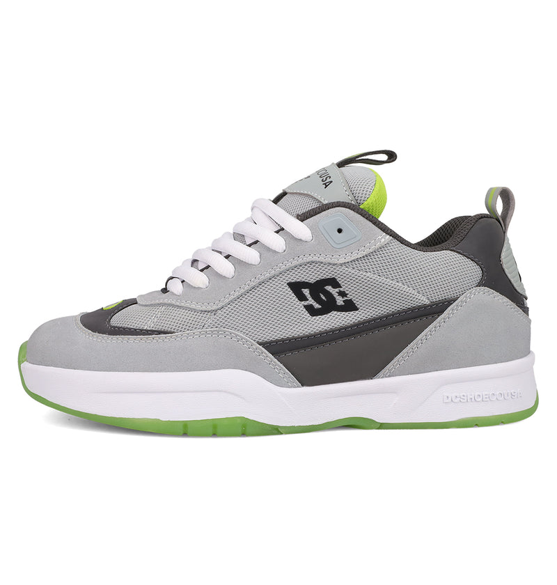 The Men's JS 2 Shoes by DC Shoes are gray and black skate shoes featuring white laces, a white and green sole, green accents, and the DC logo. Shown in side profile on a white background.