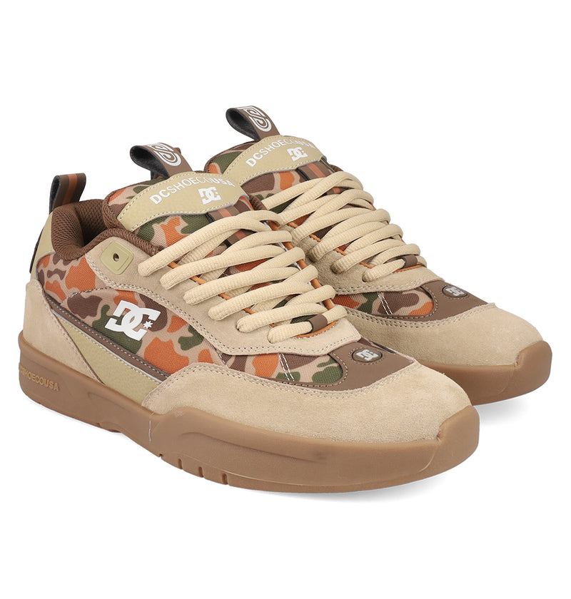 The Men's JS 2 Shoes by DC Shoes feature a heritage-inspired design with beige suede, brown and tan accents, camouflage pattern, tan laces, gum soles, and a white DC logo on the side.