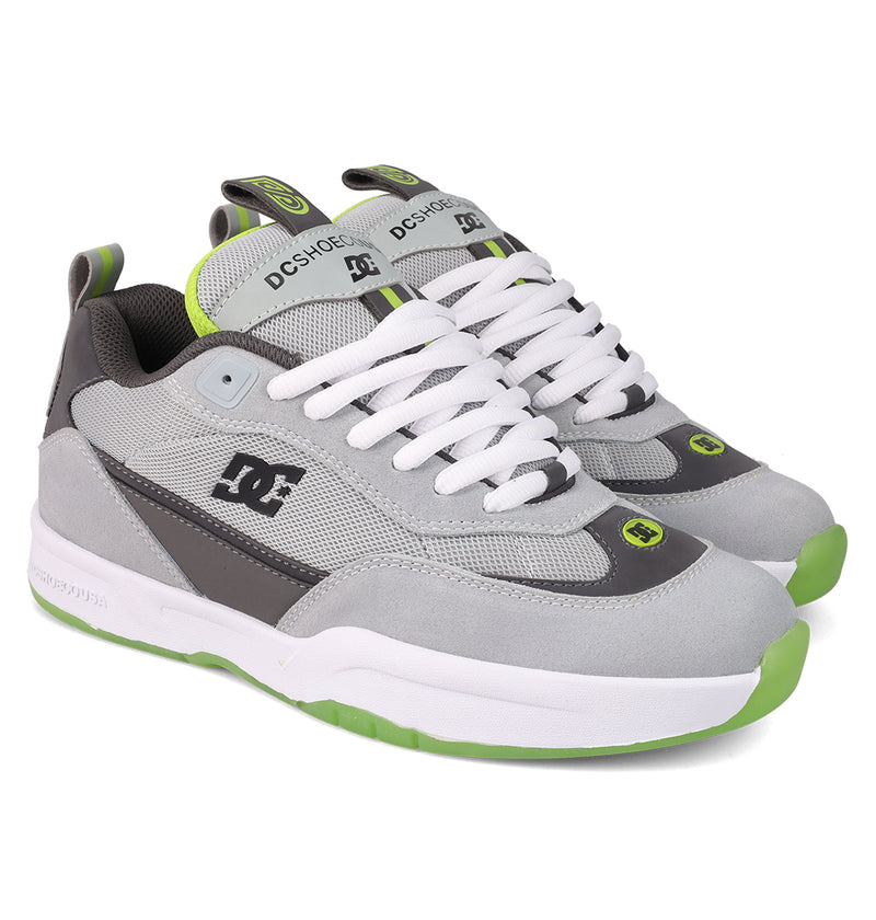 The DC Shoes Men's JS 2 Shoes feature a gray and white design with green accents, white laces, thick white sole with green treads, and showcase DC heritage style plus bold logos on the side and tongue.