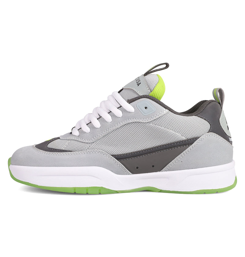 The Men's JS 2 Shoes by DC Shoes blend gray and white suede and mesh with green accents on the heel, tongue, and sole. Featuring white laces, they're inspired by DC heritage and designed with John Shanahan for the JS 2 collection.