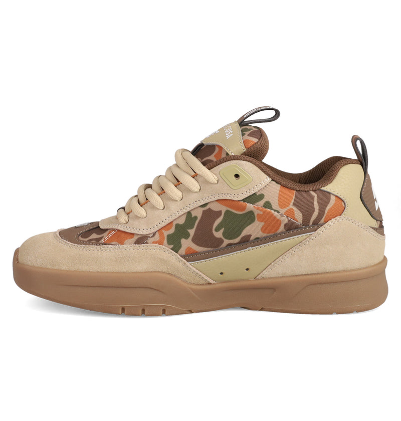 The Men's JS 2 Shoes by DC Shoes feature a tan suede upper, green-brown-orange camo fabric accents, thick tan rubber sole, beige laces, and a branded JS 2 pull tab—blending DC heritage with modern style.