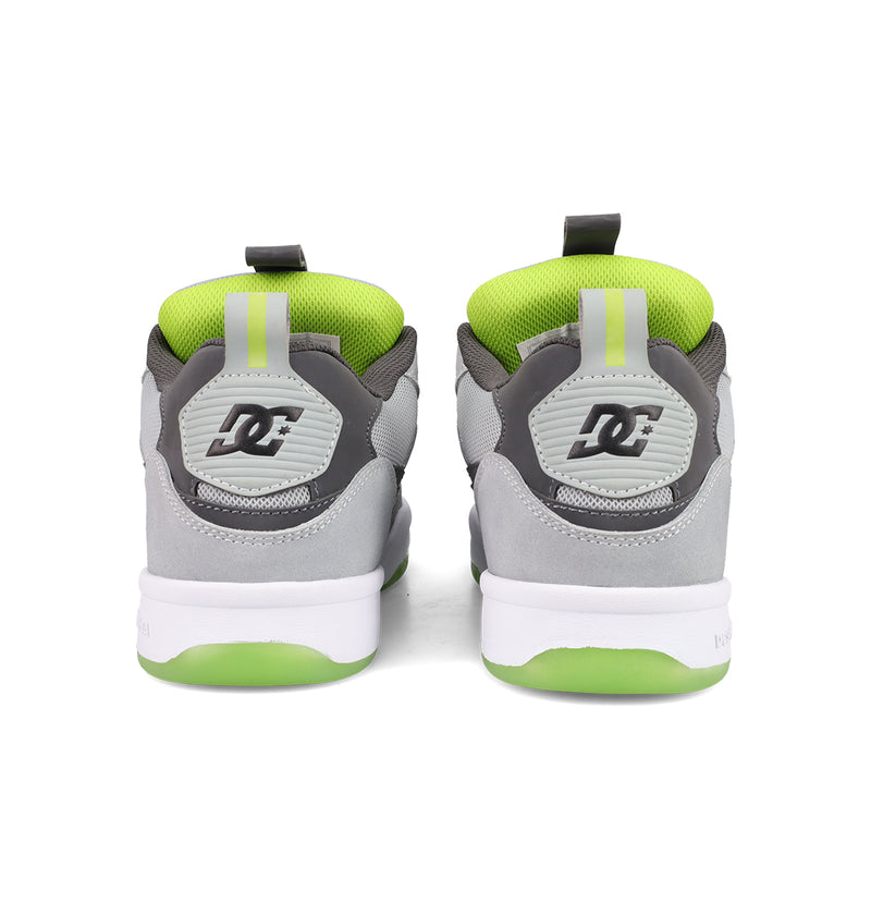 A pair of gray and white Men's JS 2 Shoes from DC Shoes seen from the back, with green inner lining, green and white soles, and the DC logo on the heel—reflecting DC Shoes heritage in every detail.
