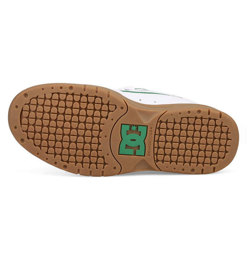 The image shows the brown rubber outsole of the DC Shoes Men's JS-2 Shanahan Pro Skate Shoes, featuring a textured grip and green DC logo at the center, reflecting classic pro model style.