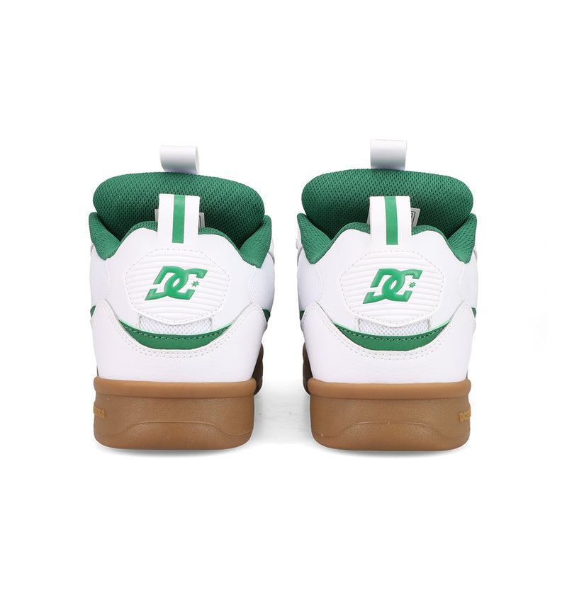 The Men's JS-2 Shanahan Pro Skate Shoes by DC Shoes are white and green sneakers seen from the back, featuring green DC logos on the heels and gum rubber soles, inspired by classic DC heritage styles.