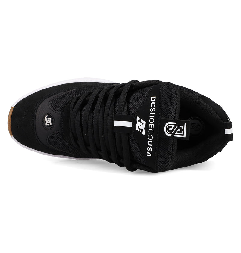 Top view of the Men's JS-2 Shanahan Pro Skate Shoes by DC Shoes in black, featuring black laces, white DC Shoes USA tongue branding, a white DC logo near the toe, and a white sole with a brown toe tip.