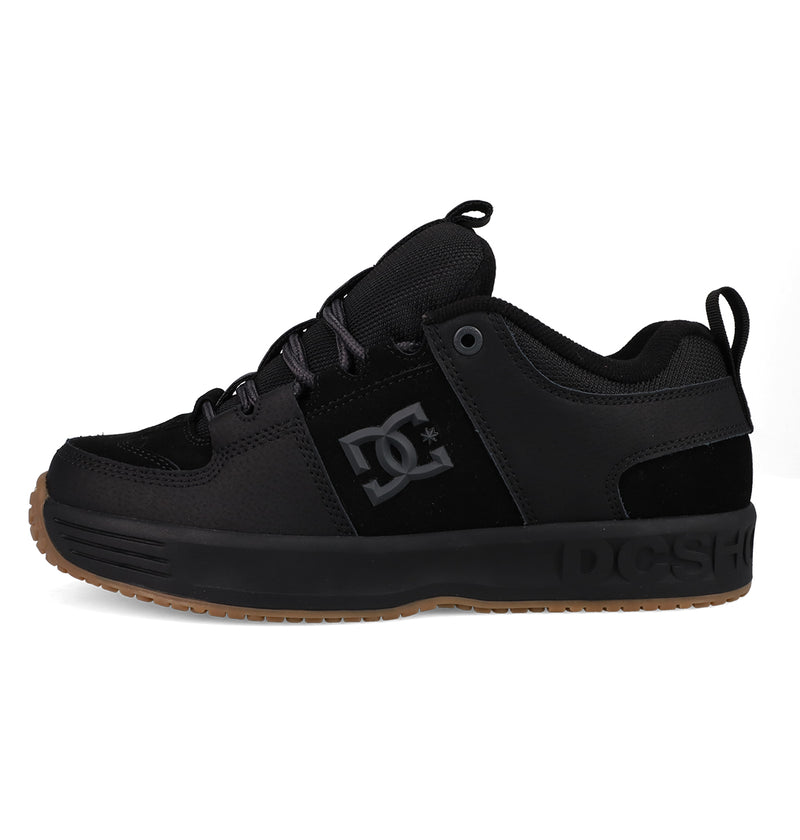 The Men's Lynx OG Shoes by DC Shoes feature a black mesh and suede upper, gum sole, black laces, side DC logo, low-cut skate-friendly design, and a heel loop—making them a DC Team favorite for skateboarding.