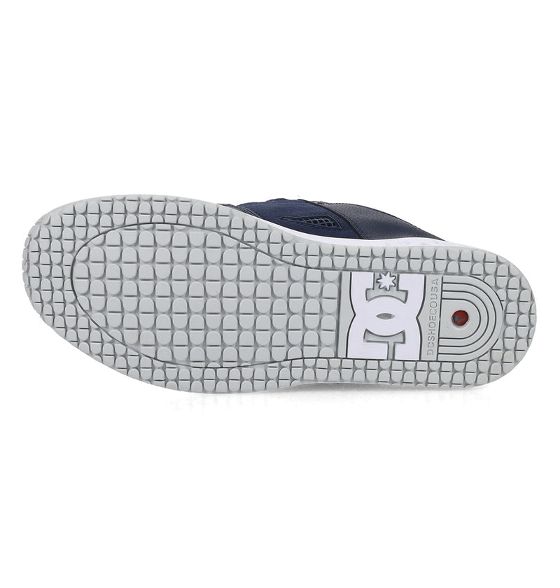 Navy blue sneaker with white sole on a white background