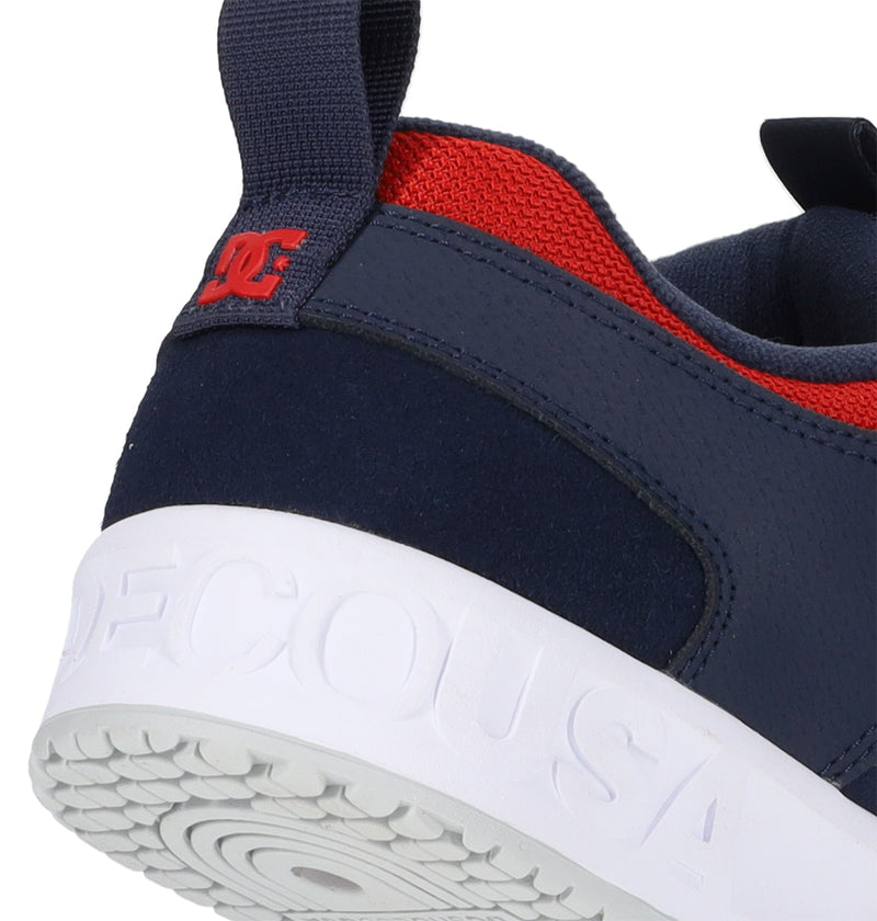 Navy and red sneaker with a white sole on a white background