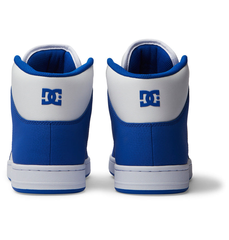 A pair of Men's Manteca 4 HI high-top shoes by DC Shoes in blue and white, shown from the back with a leather upper and the DC Shoes logo on the heels, set against a plain white background.