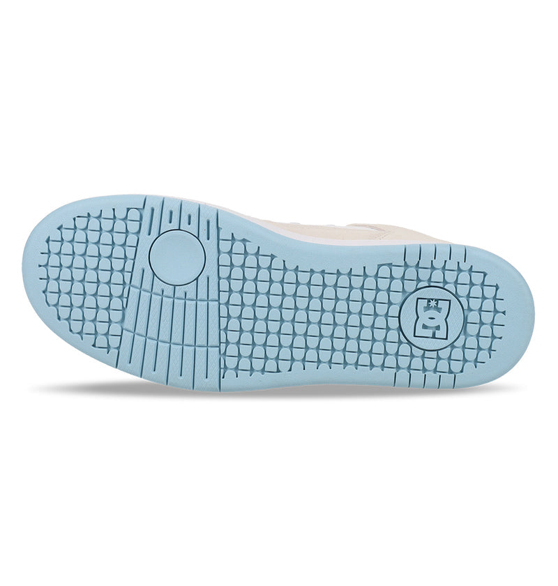 The image shows the light blue sole of the DC Shoes Manteca 4 Hi sneaker, featuring a textured pattern, circular grooves near the toe, and a hexagonal logo with a bear figure by the heel against a white background.