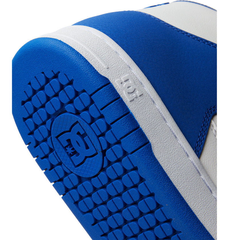 Close-up of the blue and white sole on DC Shoes Men's Manteca 4 HI Shoes, showcasing a textured, durable outsole with the DC Shoes logo embossed at the center of the blue section.