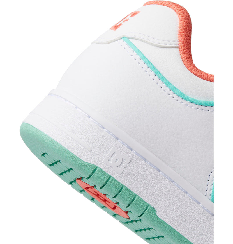 Close-up of the heel of the Men's Manteca 4 SE Shoes by DC Shoes, featuring a white upper, mint green sole, coral accents, and textured finish. The DC Shoes logo appears on the heel and sole, showcasing its performance-focused design.