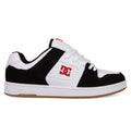 A black and white DC Shoes Men's Manteca 4 with a gum sole, white laces, red DC logo on side and tongue, plus suede accents. This low-cut sneaker offers classic style for skate or streetwear.