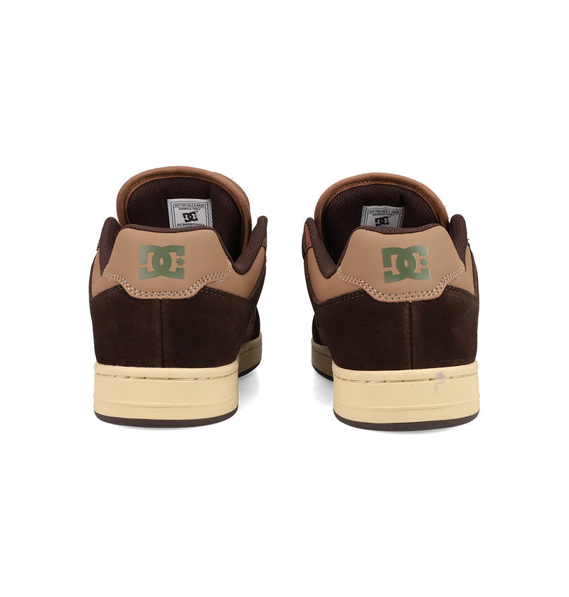 A pair of brown and tan Men's Manteca 4 Shoes by DC Shoes viewed from the back, featuring green DC logos on the heels and cream-colored soles—classic skate shoes with timeless style.