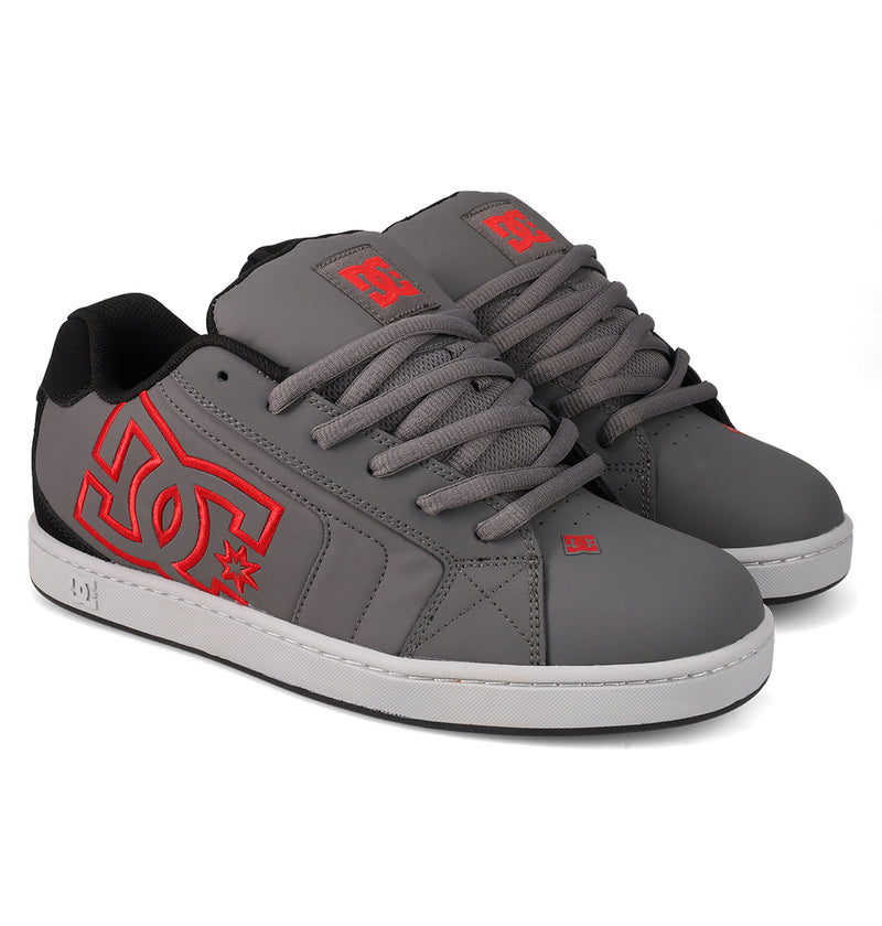 DC Shoes Men's Net Shoes feature a gray colorway with bold red DC branding on the sides, gray laces, black lining, and durable white soles.