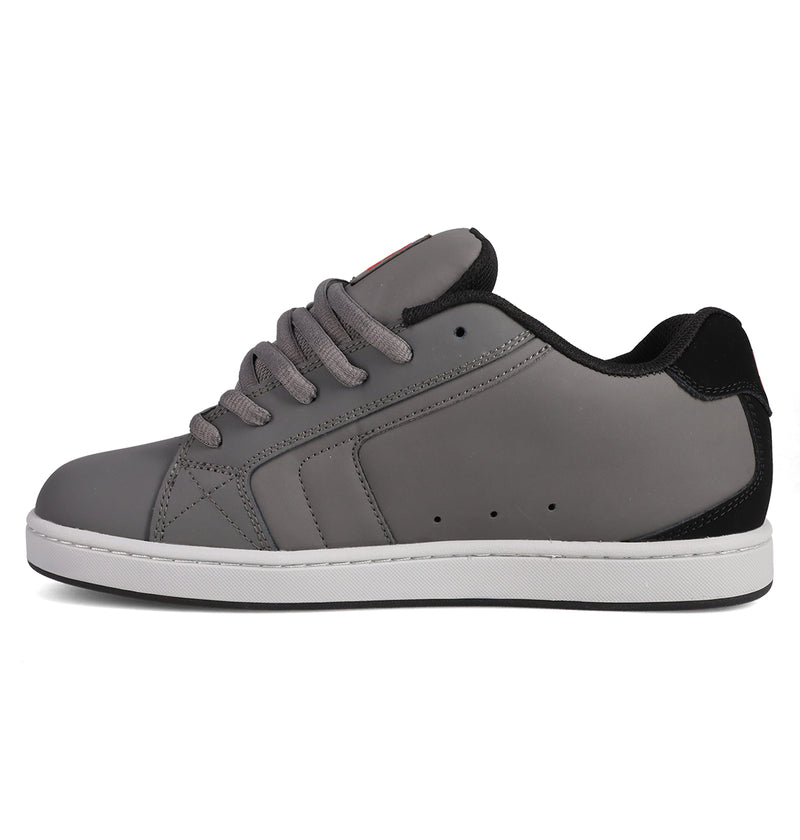 The Men's Net Shoes by DC Shoes are grey and black sneakers with a white sole, grey laces, and black accents on the heel. Featuring DC branding, they’re crafted from durable fabrics and shown in a side view.