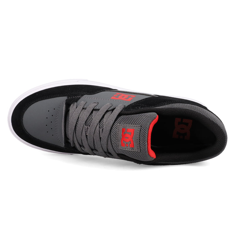 The DC Shoes Men's Onyx features a black and gray design with gray laces, a red DC logo on the tongue, and a white sole, offering a minimal silhouette from above.