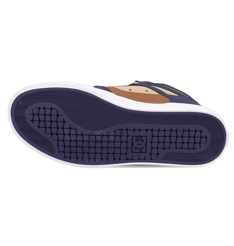 The image displays the sole of the DC Shoes Men's Pure High Top WC Shoes, featuring a purple grid-patterned tread with the DC logo in the center. The sneaker has white sidewalls, tan and purple accents, and a durable vulcanized outsole.