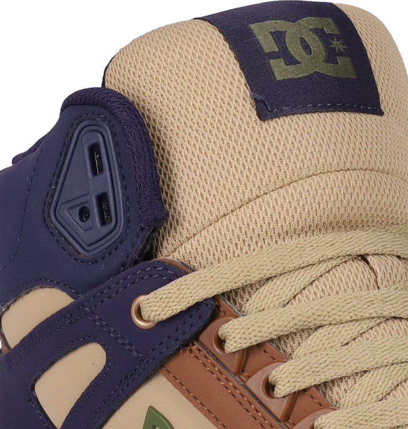 Close-up of the Men's Pure High Top WC Shoes by DC Shoes, showcasing tan mesh, beige laces, a purple padded tongue with a green DC Shoes logo, plus purple, brown, and beige leather accents near the eyelets. Durable vulcanized outsole.