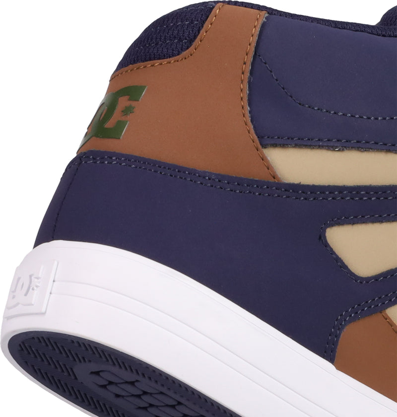 Close-up of the heel of the Men's Pure High Top WC Shoes by DC Shoes, showcasing a green logo, navy blue, brown, beige, and white hues, plus a textured vulcanized outsole for classic skate style.