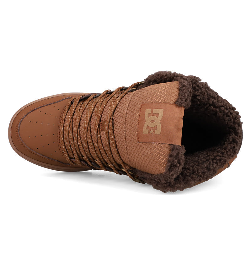 Top view of the Men's Pure High Top WC Shoes by DC Shoes in brown, featuring a textured tongue with DC logo, brown laces, fluffy dark brown lining, and a vulcanized outsole.