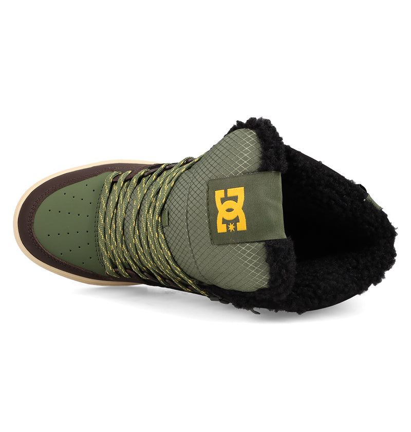 Top view of the Men's Pure High Top WC Shoes by DC Shoes in green and brown, featuring yellow laces, black fleece lining, a DC logo on the tongue, and vintage-inspired textured patterns on the tongue and side panels.