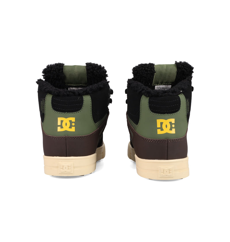Back view of two DC Shoes Men's Pure High Top WC Shoes in green, brown, and black with cream soles, yellow DC logos on the heels, and black fleece ankle lining for a vintage-inspired skate style.
