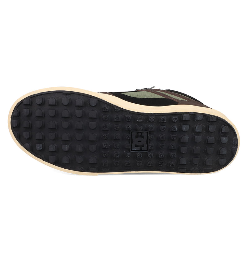The image shows the bottom view of DC Shoes Men's Pure High Top WC Shoes with a black rubber sole, a grid of raised squares, the DC Shoes logo in the center, and a beige edge.