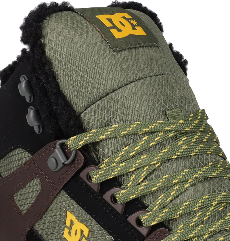 Close-up of the Men's Pure High Top WC Shoes by DC Shoes in green with yellow branding, detailed stitching, green and yellow laces, brown and black accents, and a textured tongue lined with black fleece.