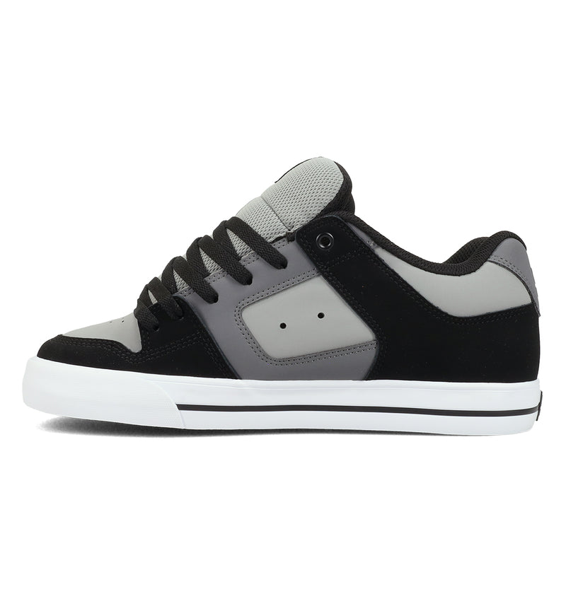 The Men's Pure Shoes by DC Shoes are black, gray, and white low-top skate shoes with black laces, a white sole, and a padded gray tongue; shown in side view for versatile style and comfort.