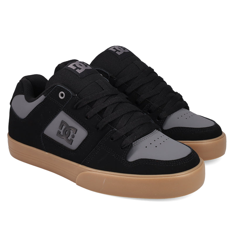 DC Shoes Men's Pure Shoes feature black and gray uppers, black laces, a gray side logo, and light brown rubber soles. These comfortable sneakers are displayed on a white background.