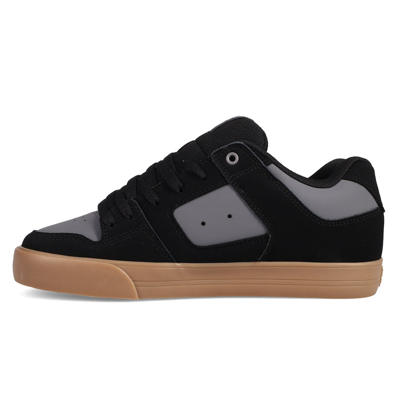The DC Shoes Men's Pure Shoes feature a black and gray low-top design with a gum-colored rubber sole, displayed in side profile on a white background. These sneakers combine comfort and style for any occasion.