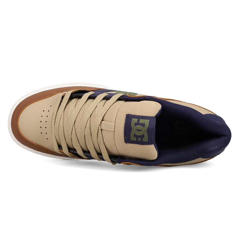 Top view of a men's Pure Shoe by DC Shoes in tan and navy, with beige laces, perforated toe box, and padded tongue featuring a green DC logo—ideal for comfort.