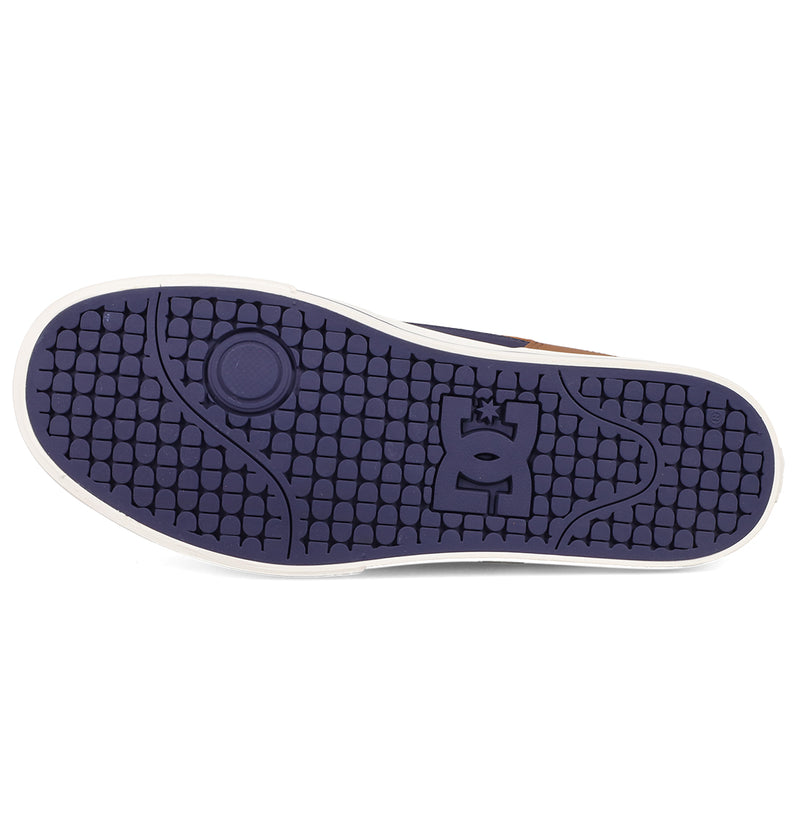 The image shows the purple rubber sole of DC Shoes Men's Pure Shoes with a textured square pattern, DC Shoes logo at the center, and a white outer edge for a modern look.